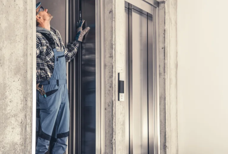 Caucasian Residential Elevator Technician in His 40s Performing Scheduled Maintenance.