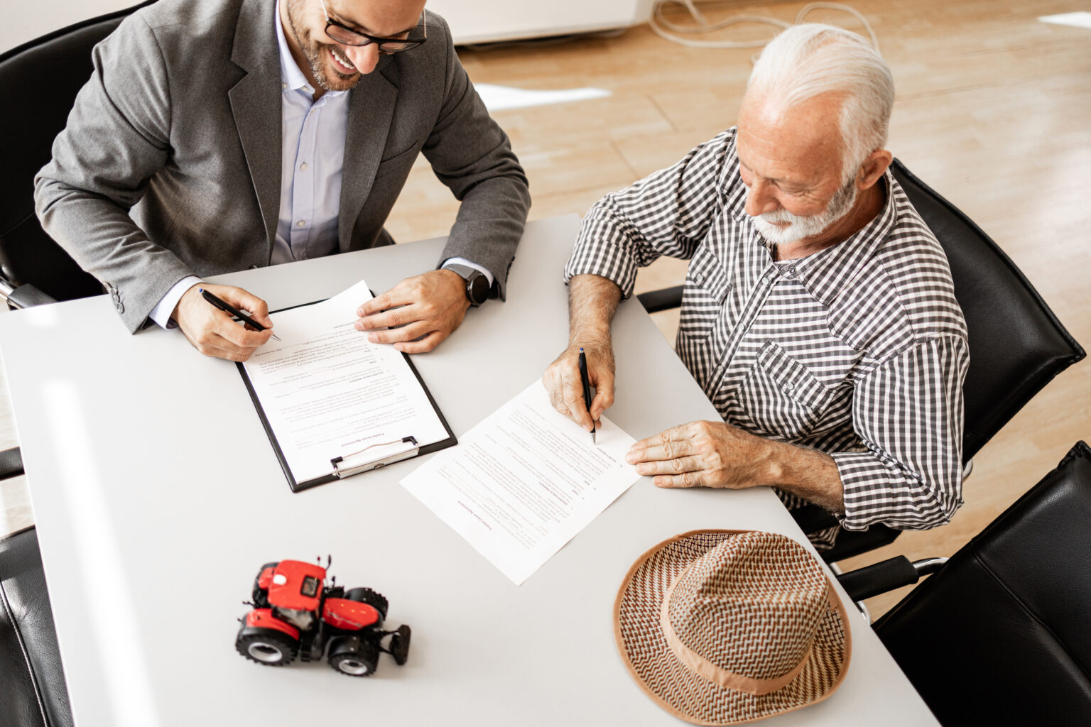 vendor management. Farmer signing contract and buying new agricultural machinery and farming equipment at dealership.