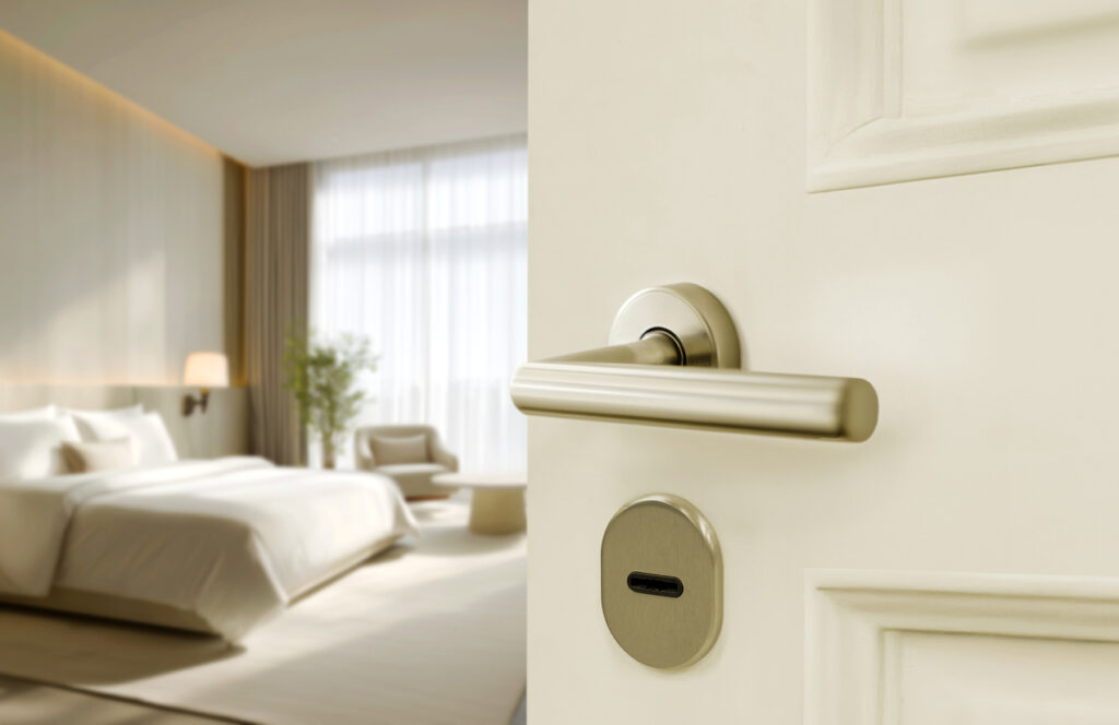 Half opened white door of hotel room or apartment doorway with and blur light interior background