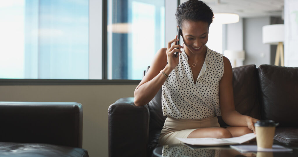 Business, woman and reading document with phone call for discussion, finance contact and investment. Person, mobile and paperwork for conversation, financial report and chat for proposal information