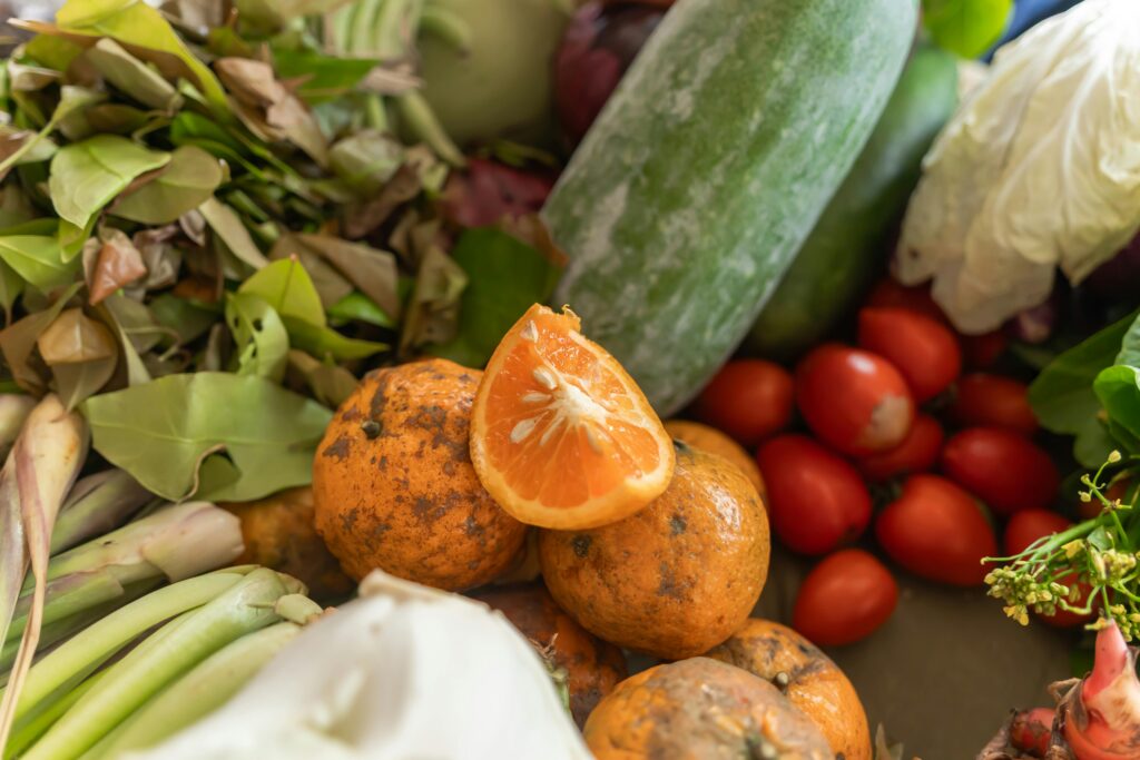 Overripe and moldy fruits and vegetables representing food waste in hospitality kitchens