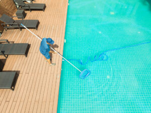 Pool maintenance with scoop net and automatic robot cleaner.