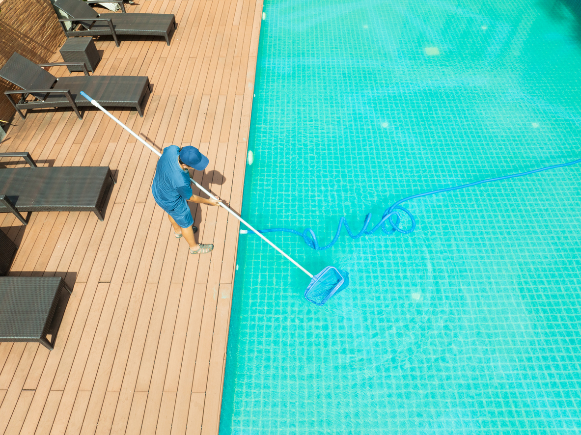 Pool maintenance with scoop net and automatic robot cleaner.